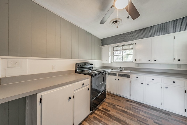 kitchen with black range with electric stovetop, dark hardwood / wood-style flooring, white cabinets, and sink