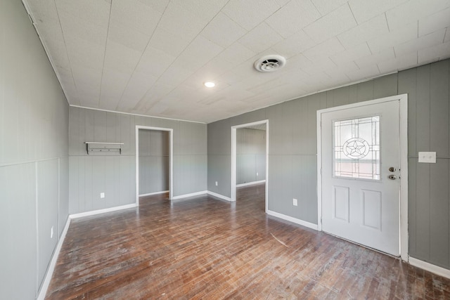 entryway featuring hardwood / wood-style flooring and wood walls