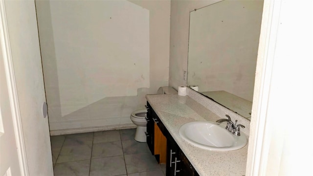 bathroom featuring tile patterned floors, vanity, and toilet