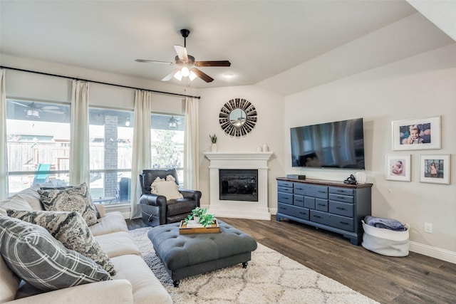 living room with ceiling fan, dark hardwood / wood-style flooring, and lofted ceiling