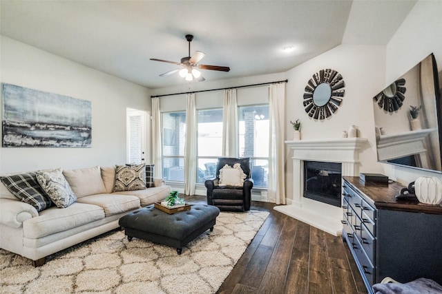 living room featuring dark hardwood / wood-style flooring, vaulted ceiling, and ceiling fan