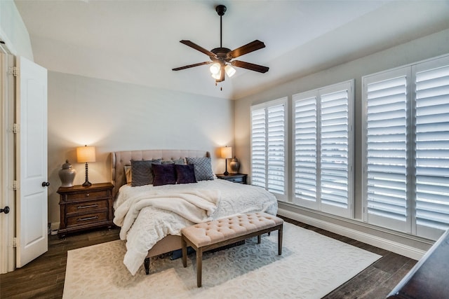 bedroom with ceiling fan and dark hardwood / wood-style flooring