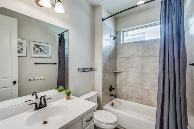 full bathroom with shower / tub combo with curtain, vanity, and toilet