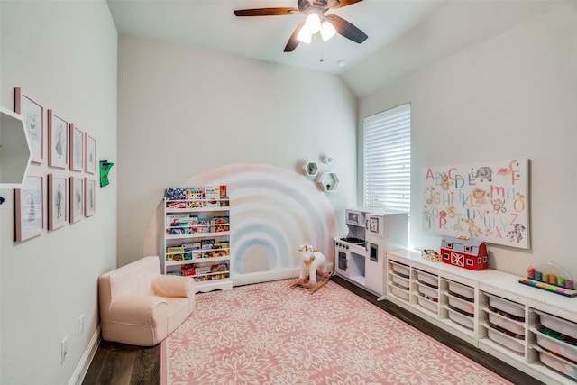 playroom with ceiling fan, wood-type flooring, and vaulted ceiling