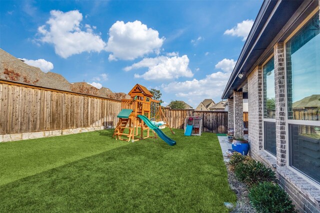 view of playground featuring a lawn