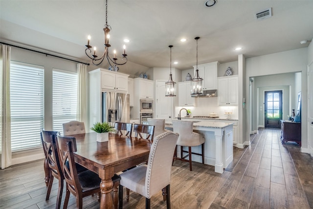 dining room with hardwood / wood-style flooring and sink