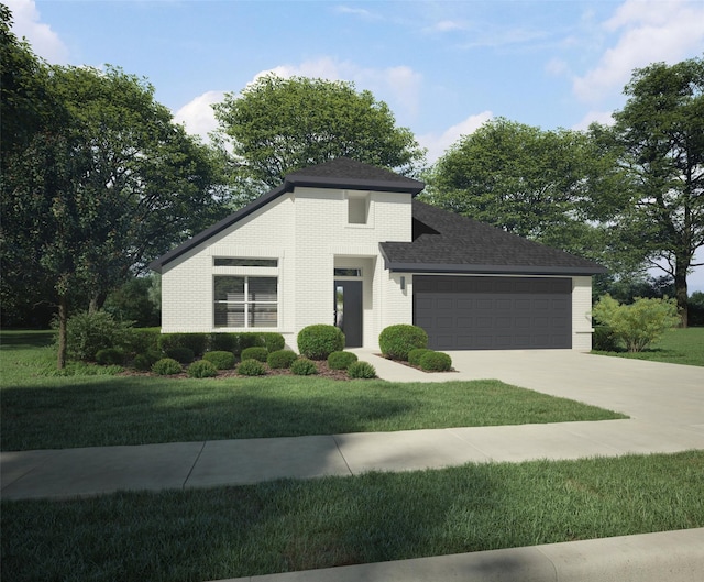 view of front of property with a front yard and a garage