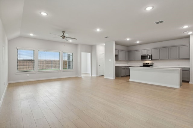 kitchen featuring a center island, stainless steel appliances, and light hardwood / wood-style flooring