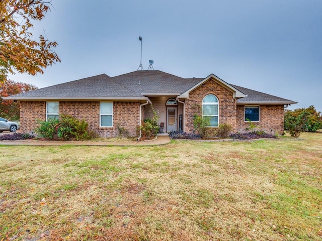 ranch-style home featuring a front yard