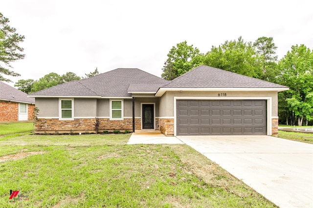 view of front of property featuring a garage and a front lawn