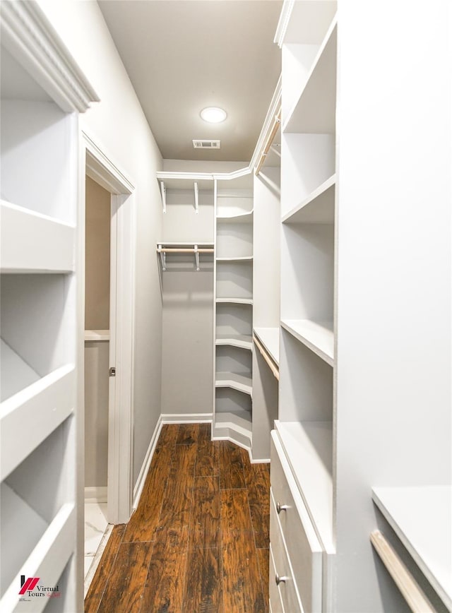 walk in closet featuring dark hardwood / wood-style flooring