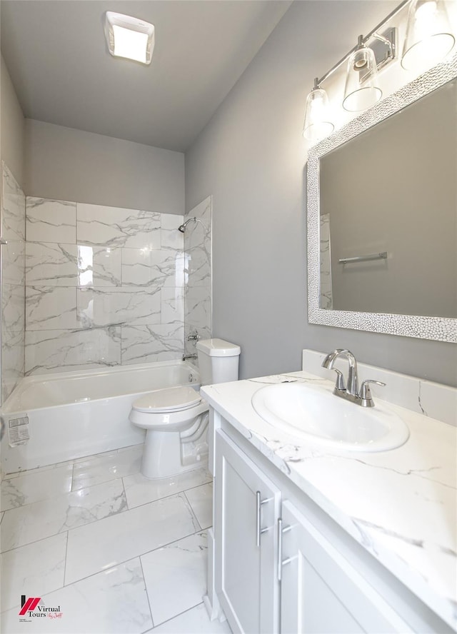 full bathroom with toilet, vanity, and tiled shower / bath