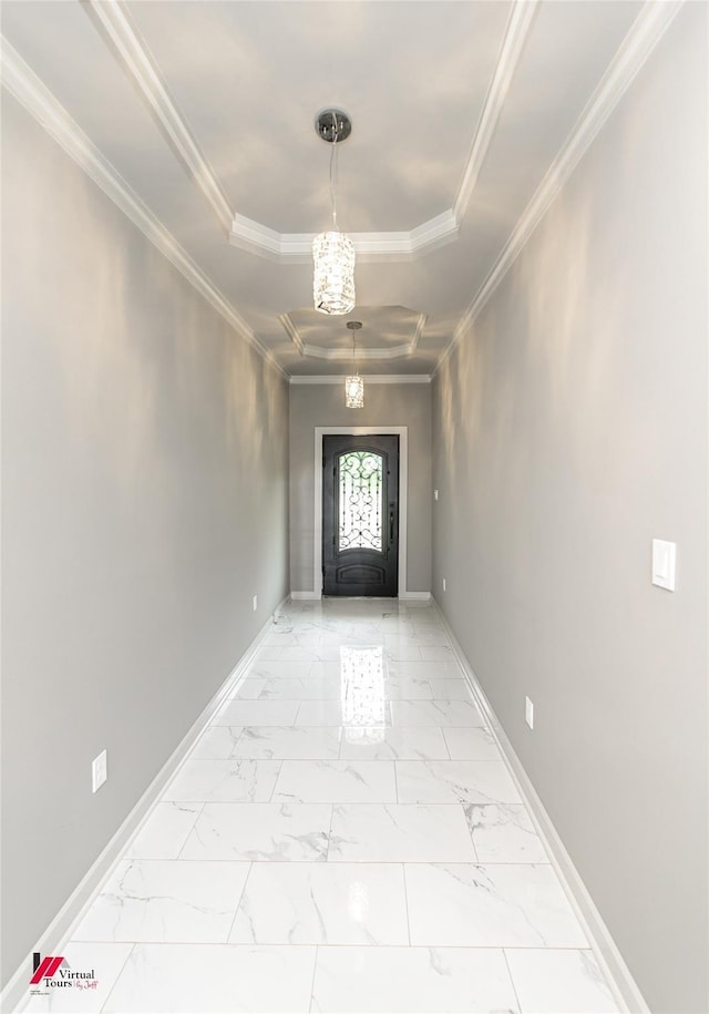 doorway to outside featuring crown molding, a tray ceiling, and a notable chandelier