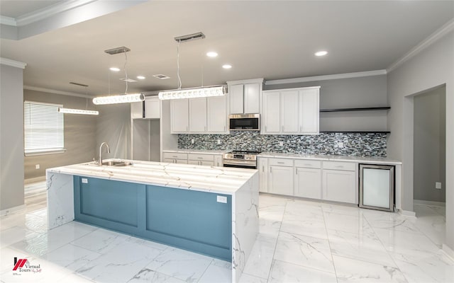 kitchen featuring light stone countertops, stainless steel appliances, sink, a center island with sink, and hanging light fixtures