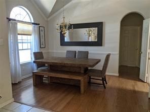 dining room with hardwood / wood-style floors and lofted ceiling