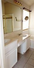 bathroom featuring tile patterned flooring and vanity