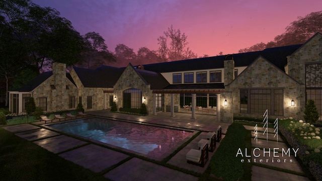 pool at dusk with a patio area