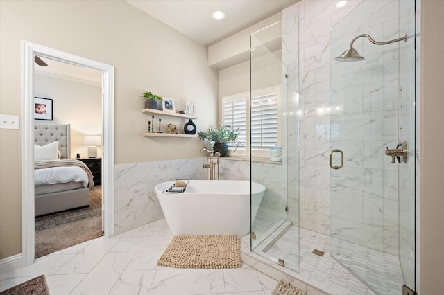 bathroom featuring tile walls and separate shower and tub