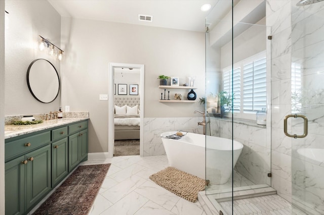 bathroom with vanity, tile walls, and independent shower and bath