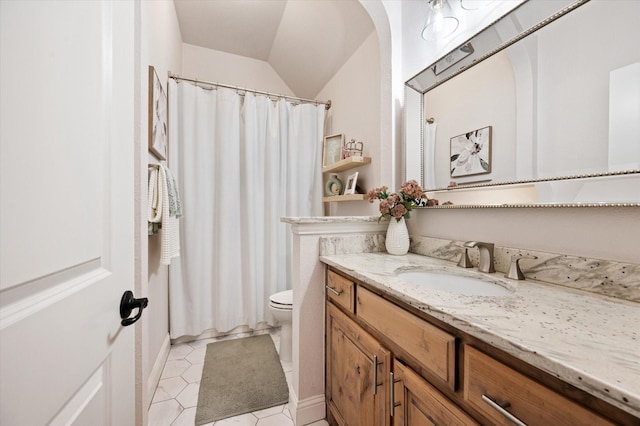 bathroom featuring toilet, vaulted ceiling, tile patterned flooring, a shower with shower curtain, and vanity