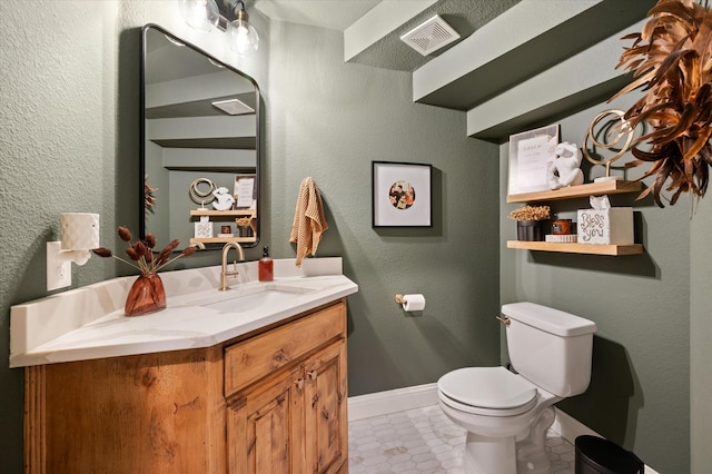 bathroom featuring toilet, vanity, and tile patterned floors