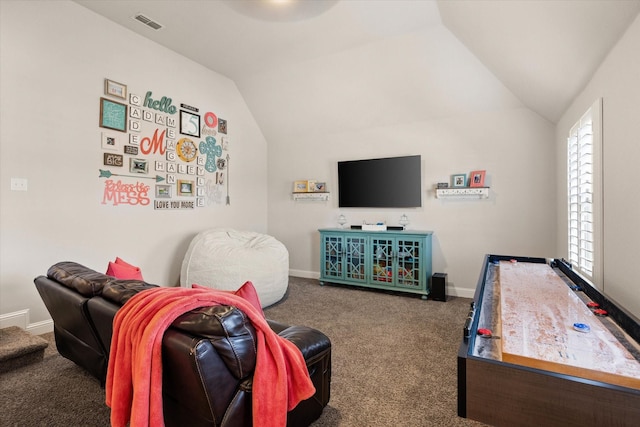 recreation room featuring vaulted ceiling and dark carpet