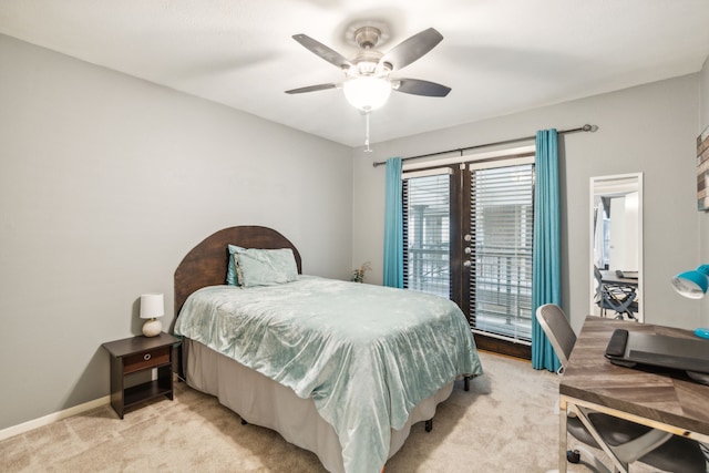 bedroom featuring access to exterior, light colored carpet, and ceiling fan