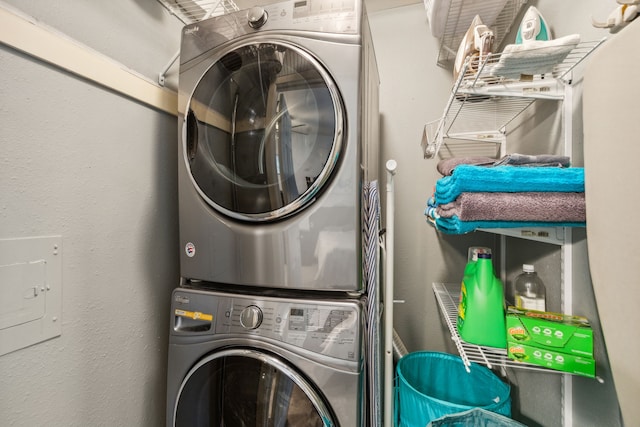 washroom with stacked washing maching and dryer