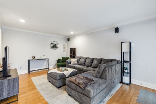 living room featuring hardwood / wood-style flooring and crown molding