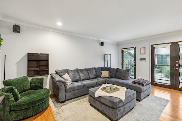 living room featuring crown molding and light hardwood / wood-style floors