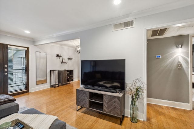 living room with hardwood / wood-style floors and ornamental molding