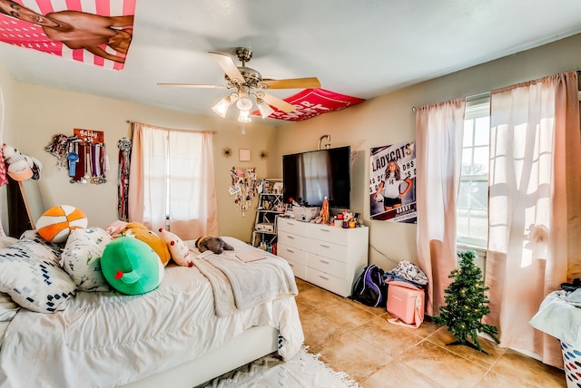 bedroom with ceiling fan and light tile patterned floors