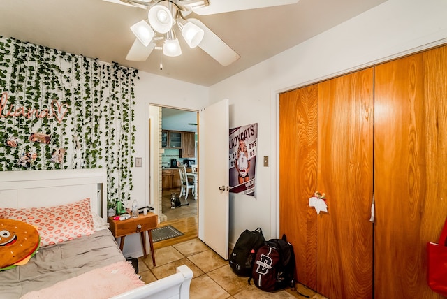 interior space featuring ceiling fan, a closet, and light tile patterned floors