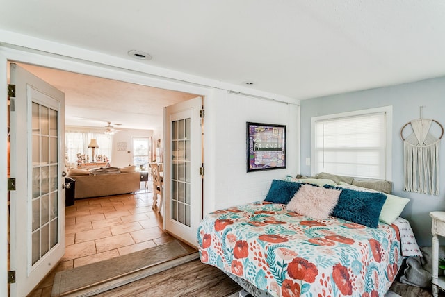 bedroom with hardwood / wood-style flooring and french doors