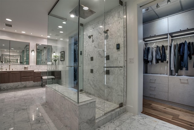 bathroom featuring vanity, wood-type flooring, and walk in shower