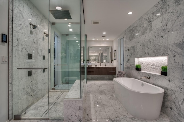 bathroom featuring vanity, shower with separate bathtub, and tile walls