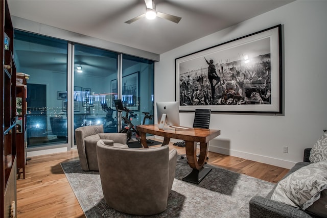 home office featuring hardwood / wood-style floors and ceiling fan