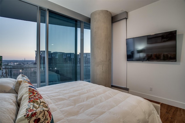 bedroom featuring hardwood / wood-style floors and expansive windows