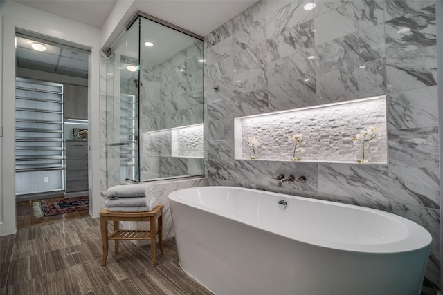 bathroom with a bathtub and tile walls