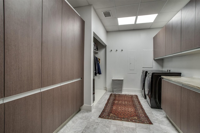 laundry area with washer and dryer and cabinets