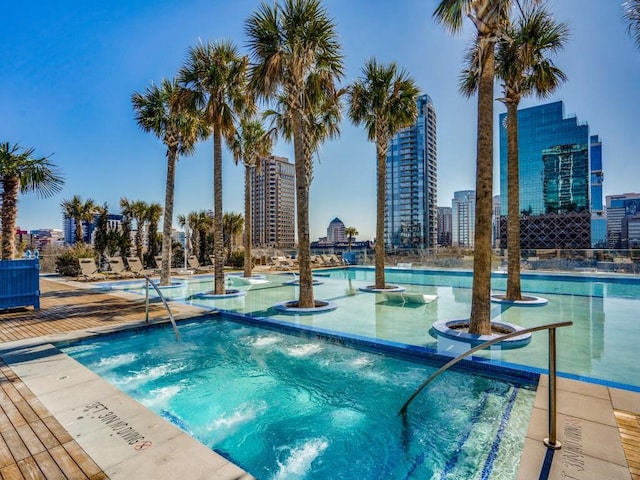 view of swimming pool with a community hot tub