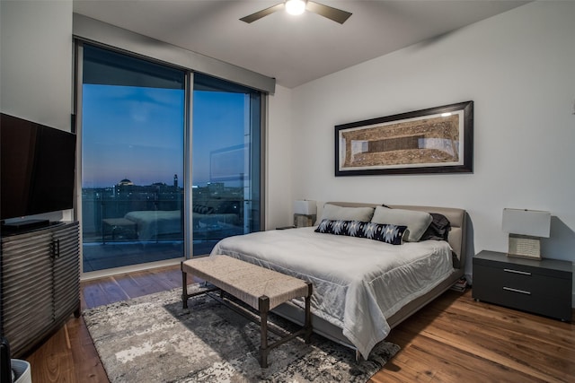 bedroom featuring access to outside, ceiling fan, and dark wood-type flooring