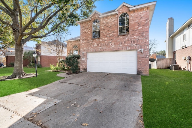 front facade with a front lawn, central AC unit, and a garage