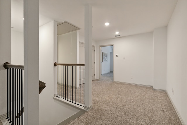 hall featuring light colored carpet