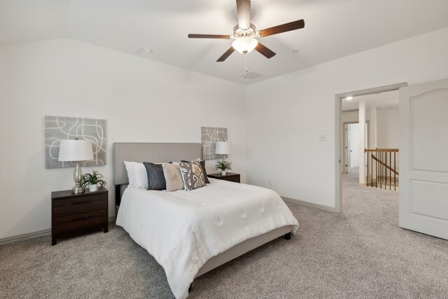 bedroom with light carpet, vaulted ceiling, and ceiling fan