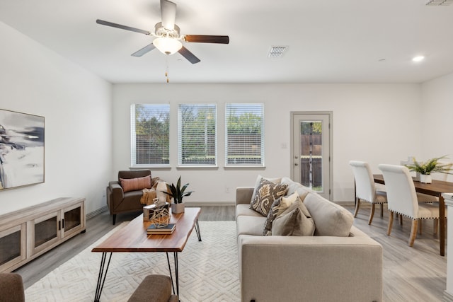 living room featuring light wood-type flooring and ceiling fan