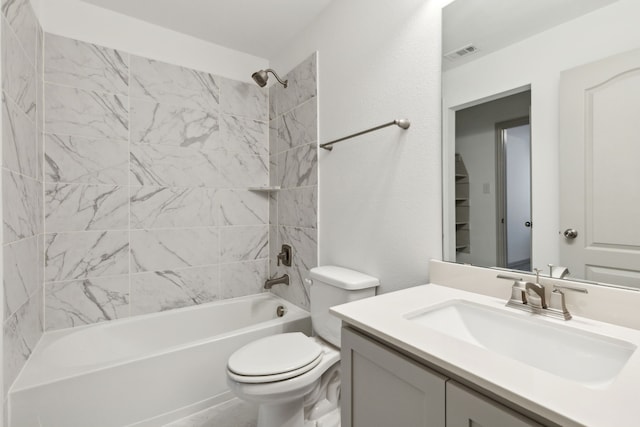 full bathroom with tiled shower / bath combo, toilet, and vanity