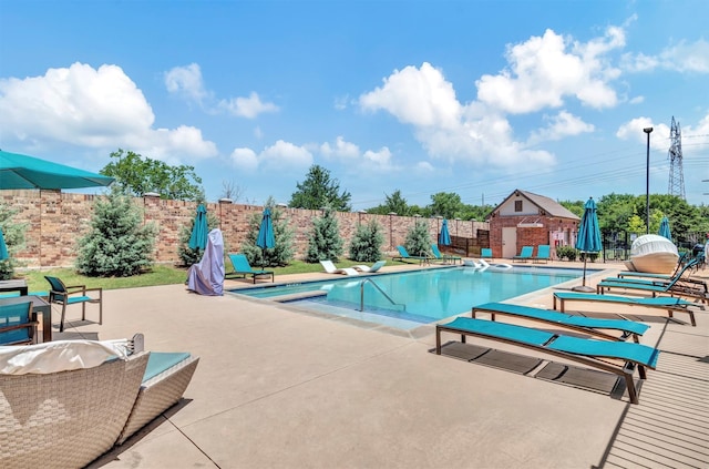 view of pool featuring a diving board and a patio area