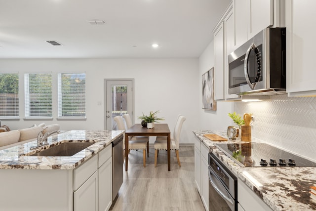 kitchen featuring white cabinets, sink, and stainless steel appliances