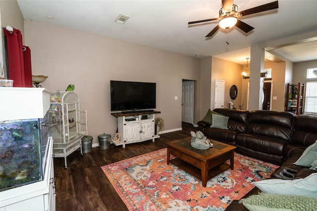 living room featuring ceiling fan and dark hardwood / wood-style flooring